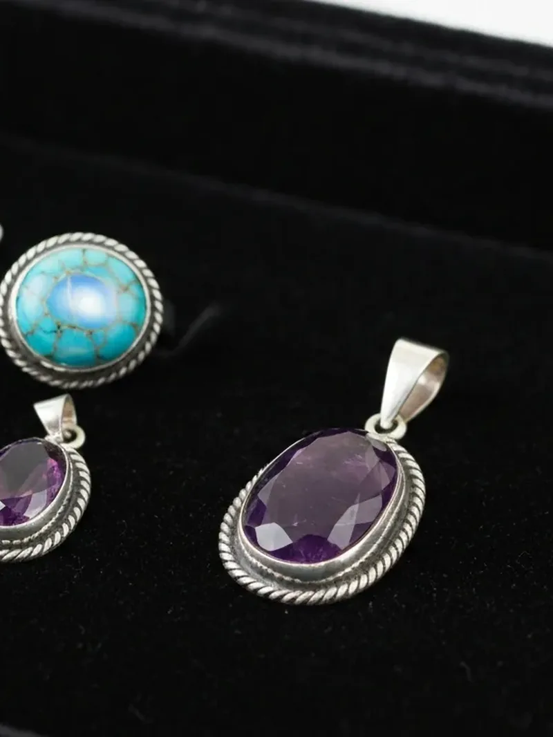 Silver pendants and a ring set with turquoise and amethyst